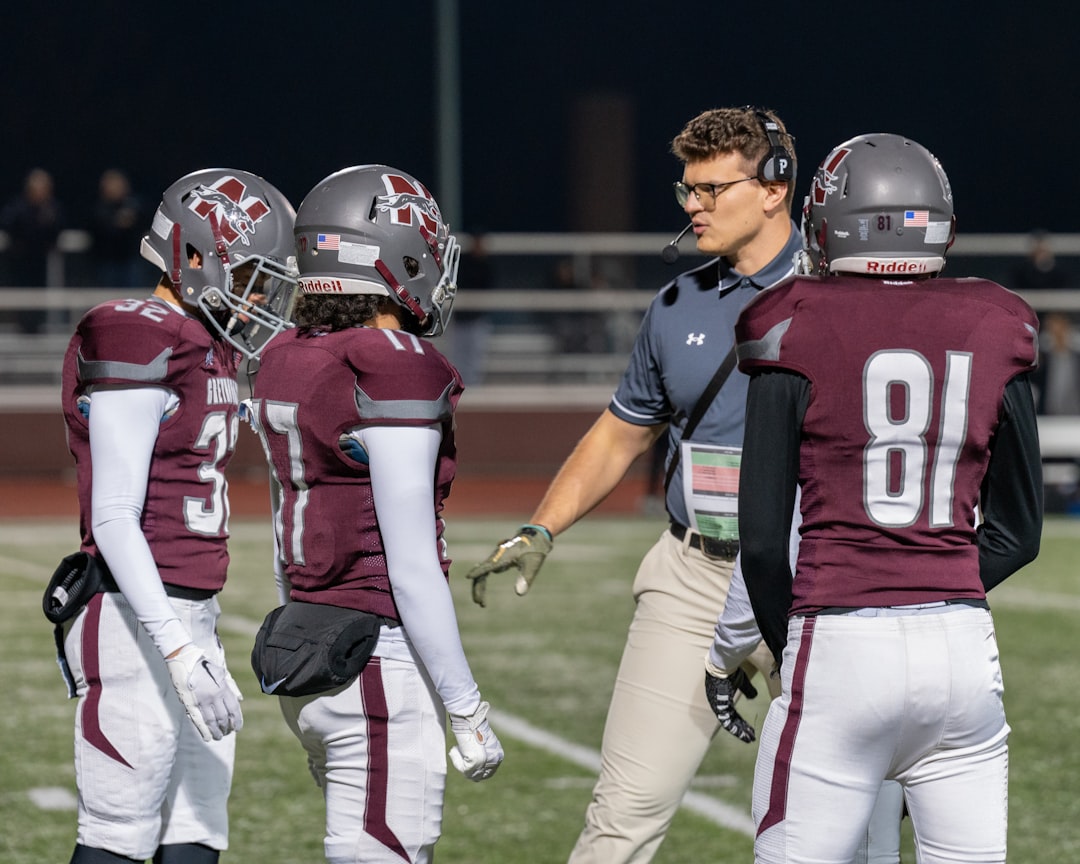 A group of football players standing on top of a field